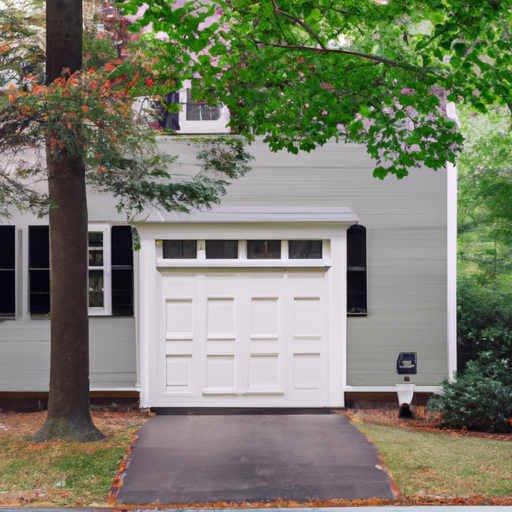 Colonial home in Concord, MA with a closed insulated garage door, smart keypad and exterior sensor visible, daylight